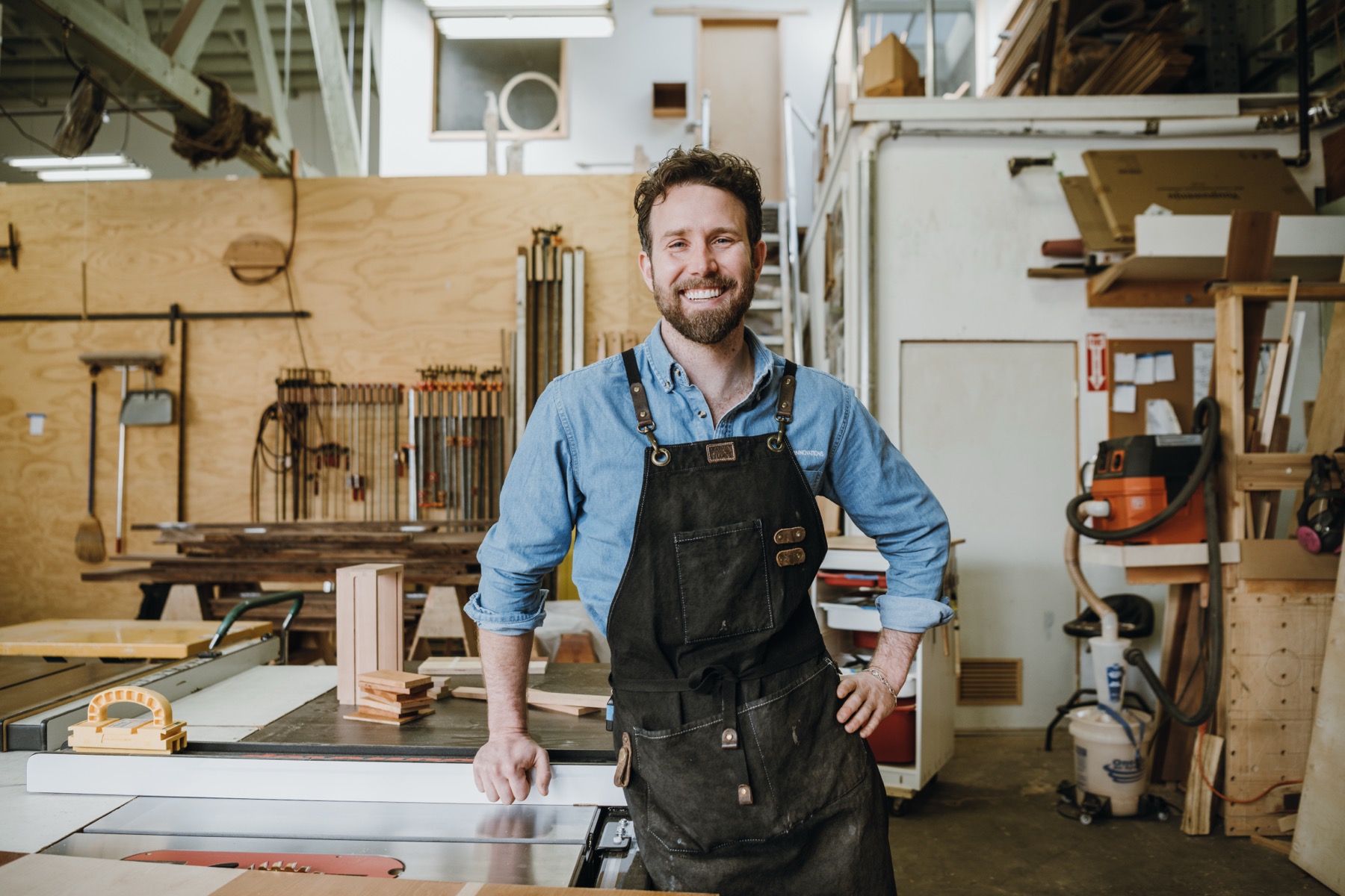 David Flatow smiling in his San Francisco woodworking workshop