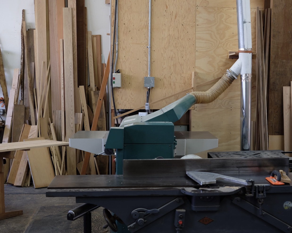 Flatow Furniture woodworking workshop with jointer and lumber