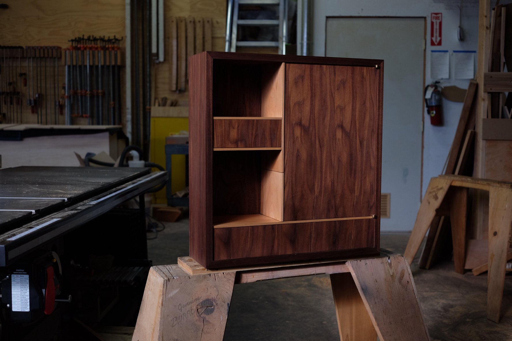 A handmade wall-hung walnut and beech cabinet