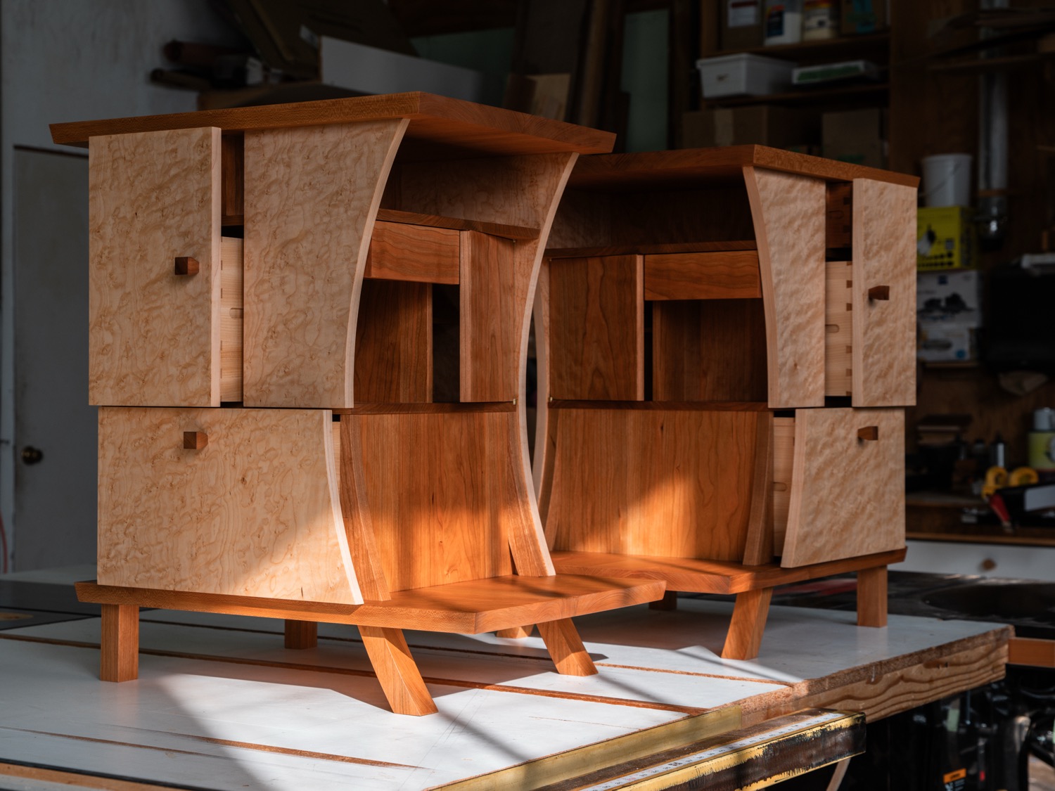Pair of nightstands showing birdseye maple drawer fronts and sunlit cherry curves